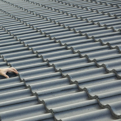 Builder Working On Roof Of New Building