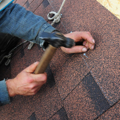 roofer install asphalt roof shingles. close up view on roofer installation  asphalt roofing shingles installation. roofing construction, roofer roofing repair.